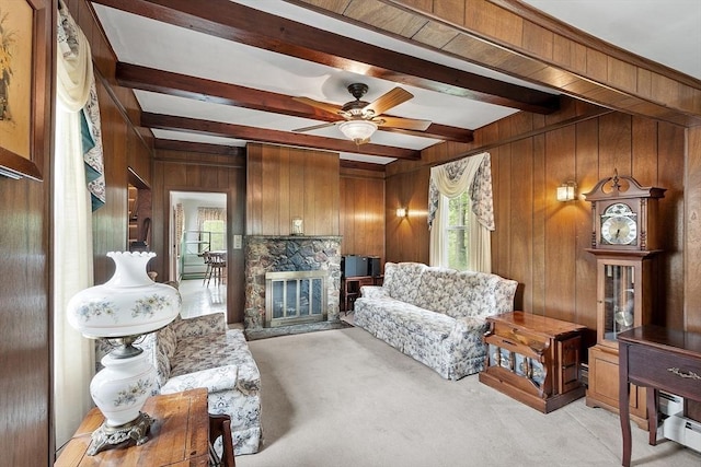 74 W Main St, Westminster, MA 01473 - living area featuring light carpet, beamed ceiling, wooden walls, ceiling fan, and a stone fireplace