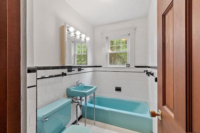 74 W Main St, Westminster, MA 01473 - bathroom featuring tile walls, a garden tub, wainscoting, and tile patterned flooring