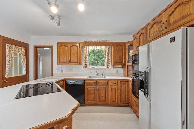 74 W Main St, Westminster, MA 01473 - kitchen featuring black appliances, brown cabinetry, light countertops, and decorative backsplash