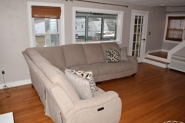 living room with hardwood / wood-style floors and radiator heating unit