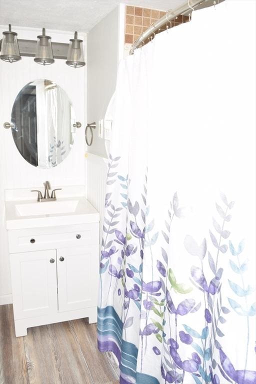 bathroom with vanity and hardwood / wood-style flooring