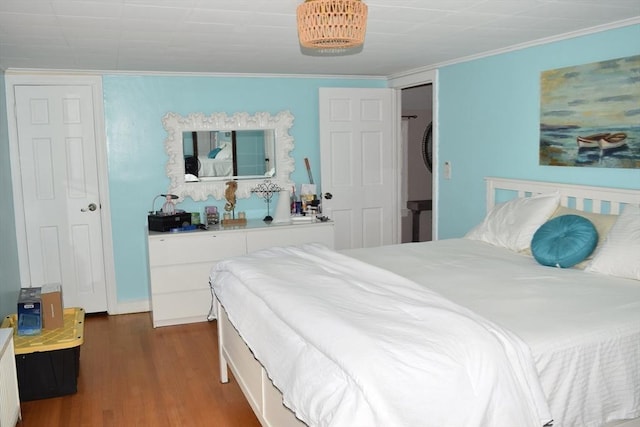 bedroom featuring dark hardwood / wood-style floors and crown molding