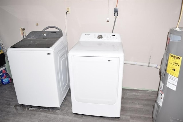 clothes washing area featuring electric water heater, dark wood-type flooring, and separate washer and dryer