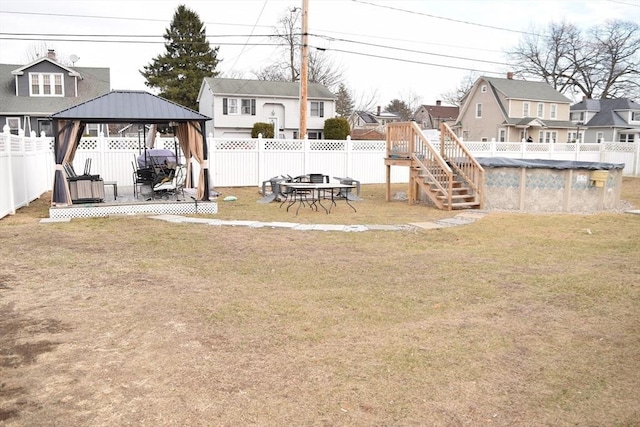 view of yard featuring a gazebo and a pool side deck