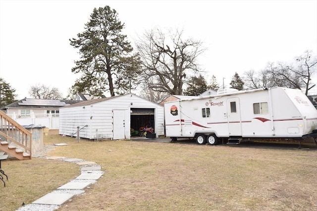 view of outbuilding with a yard and a garage