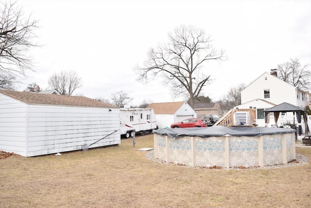 view of yard with a gazebo and a covered pool