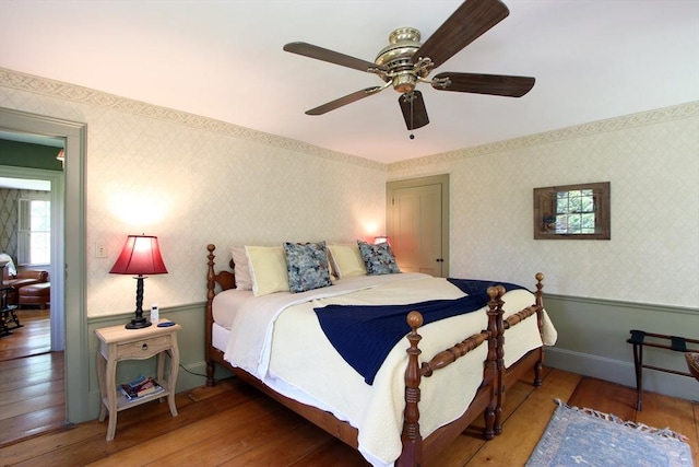 bedroom with ceiling fan and hardwood / wood-style flooring