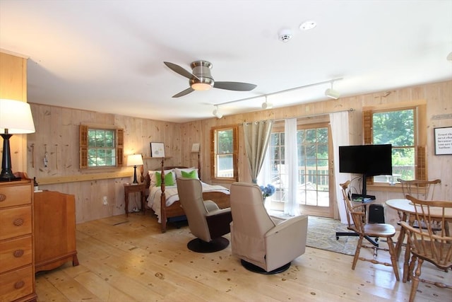 interior space featuring ceiling fan, light hardwood / wood-style flooring, and rail lighting