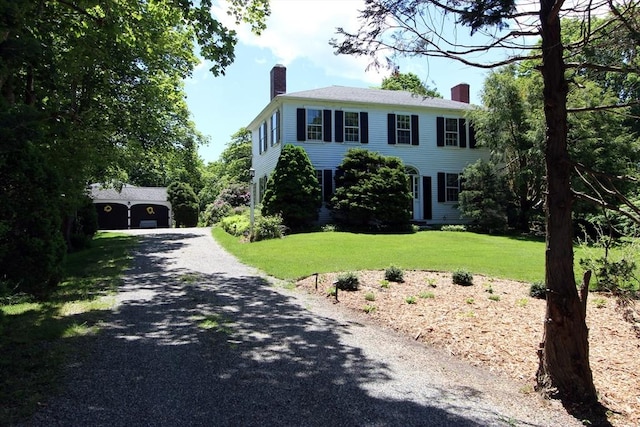 colonial-style house with a front lawn