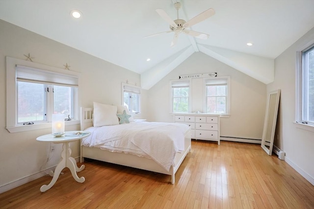 bedroom featuring baseboard heating, baseboards, light wood-style flooring, a ceiling fan, and lofted ceiling