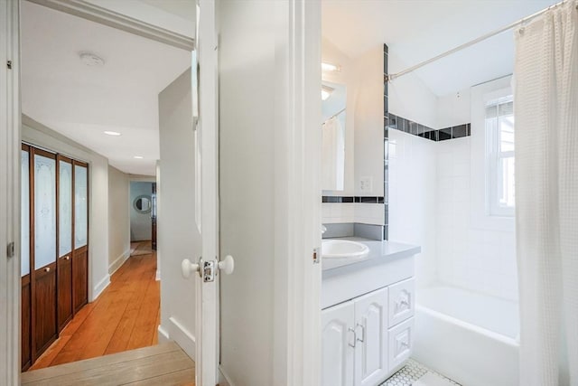 bathroom featuring shower / bath combo, vanity, and wood finished floors