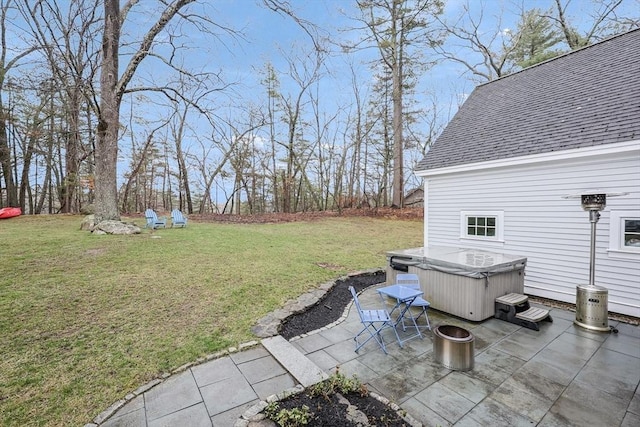 view of yard with a patio area and a hot tub