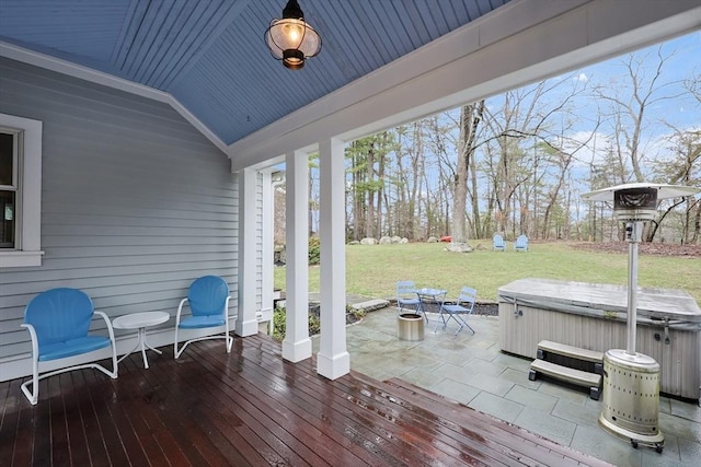 wooden terrace featuring a yard, a patio area, and a hot tub