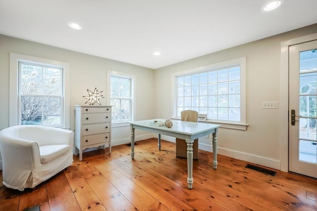 home office with light wood-type flooring, baseboards, visible vents, and recessed lighting
