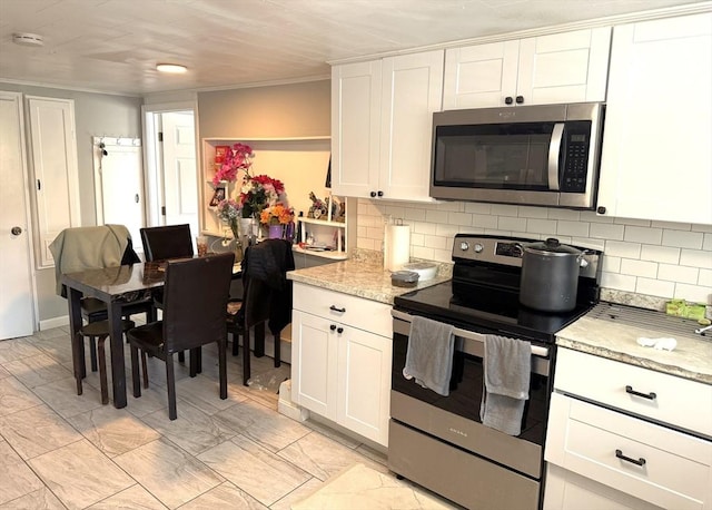 626 Nashua Rd, Dracut, MA 01826 - kitchen featuring light stone counters, decorative backsplash, appliances with stainless steel finishes, and white cabinets