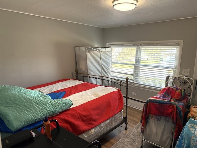 626 Nashua Rd, Dracut, MA 01826 - bedroom featuring baseboard heating and wood finished floors