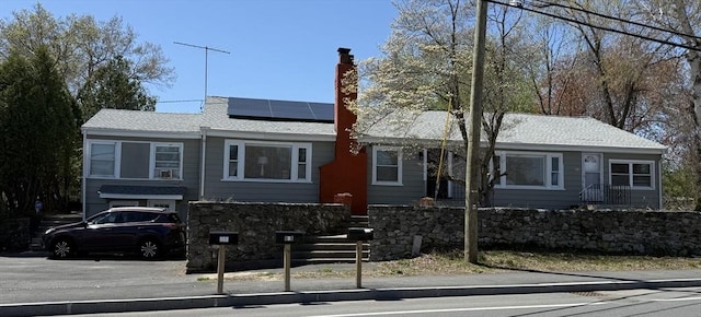 626 Nashua Rd, Dracut, MA 01826 - view of front facade featuring a chimney and solar panels
