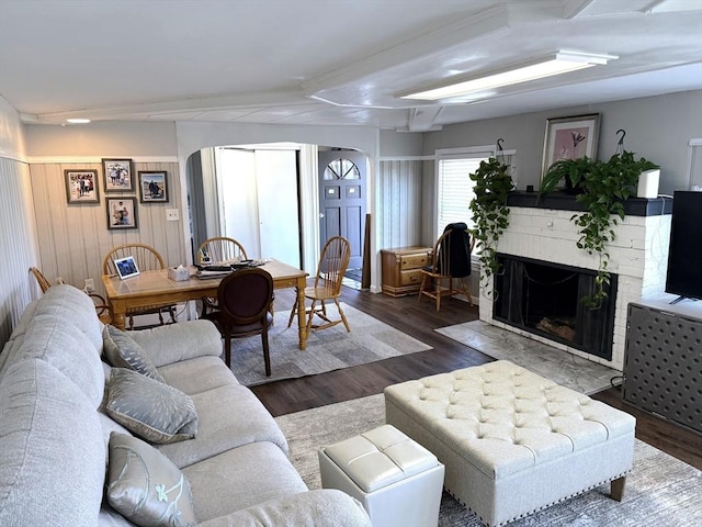 626 Nashua Rd, Dracut, MA 01826 - living room featuring a brick fireplace, arched walkways, and wood finished floors