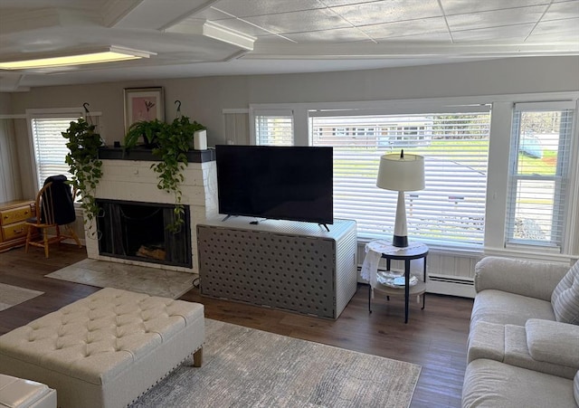 626 Nashua Rd, Dracut, MA 01826 - living room with a fireplace with flush hearth, a baseboard heating unit, and wood finished floors