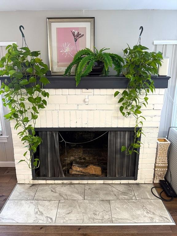 626 Nashua Rd, Dracut, MA 01826 - room details with a brick fireplace and wood finished floors
