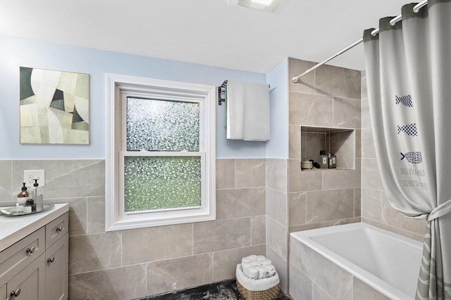 486 Franklin St, Reading, MA 01867 - bathroom with vanity, tiled shower / bath, and tile walls