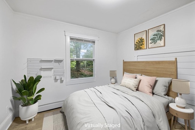 486 Franklin St, Reading, MA 01867 - bedroom with crown molding, a baseboard radiator, and wood finished floors