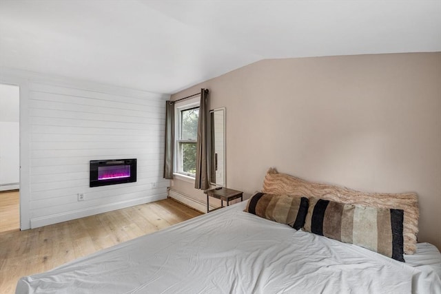 486 Franklin St, Reading, MA 01867 - bedroom featuring wood finished floors, a large fireplace, lofted ceiling, and heating unit