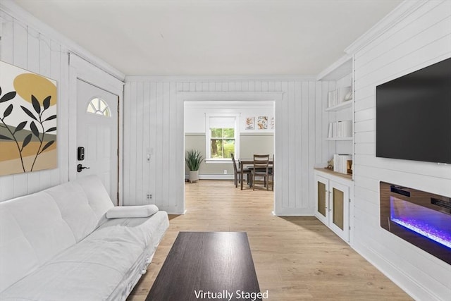 486 Franklin St, Reading, MA 01867 - living area with ornamental molding, light wood-style flooring, wood walls, and a glass covered fireplace
