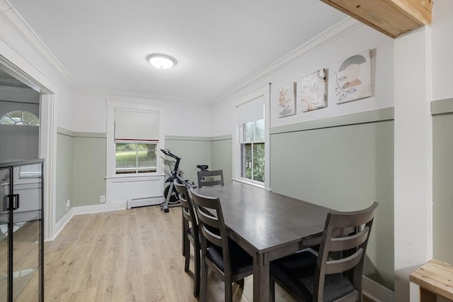486 Franklin St, Reading, MA 01867 - dining area featuring light wood-style floors, crown molding, and a baseboard radiator
