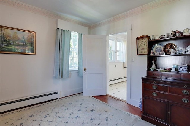 foyer entrance with a baseboard radiator and light wood-style flooring