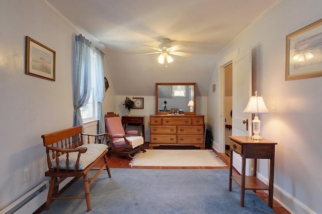 living area featuring baseboards, a ceiling fan, ornamental molding, vaulted ceiling, and a baseboard heating unit