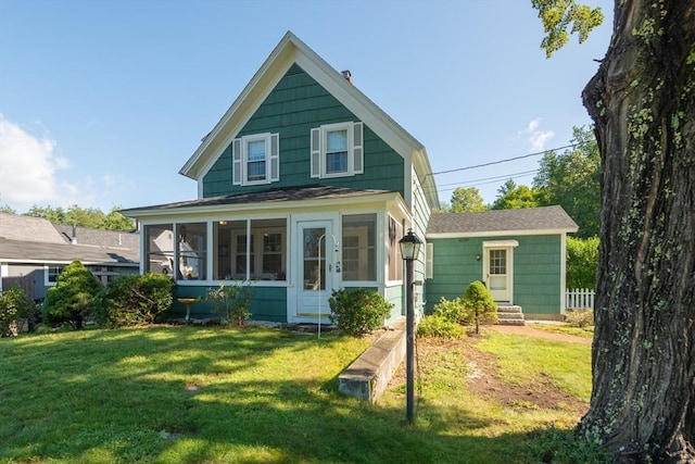 view of front of home featuring a sunroom and a front lawn