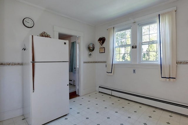 kitchen with crown molding, light floors, a baseboard radiator, a baseboard heating unit, and freestanding refrigerator