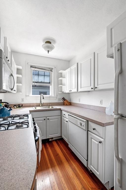 71 Ocean Ave Unit 3, Salem, MA 01970 - kitchen with white appliances, open shelves, dark wood-style flooring, white cabinets, and light countertops