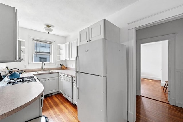 71 Ocean Ave Unit 3, Salem, MA 01970 - kitchen featuring white appliances, light wood-style flooring, light countertops, and white cabinets