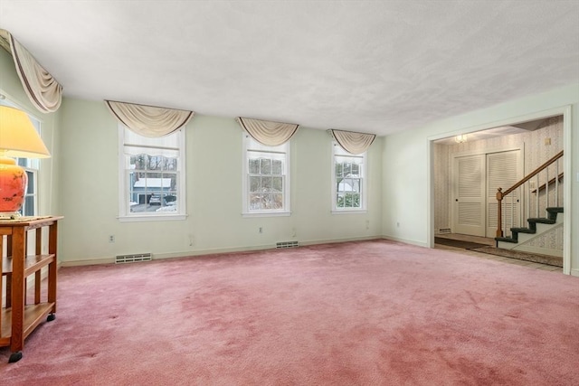 12 Checkerberry Cir, Sudbury, MA 01776 - unfurnished living room with carpet and stairs