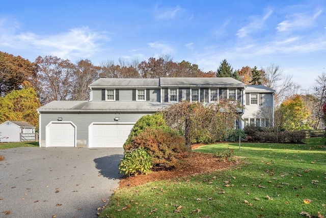 12 Checkerberry Cir, Sudbury, MA 01776 - view of front of home featuring asphalt driveway, a front lawn, and a garage