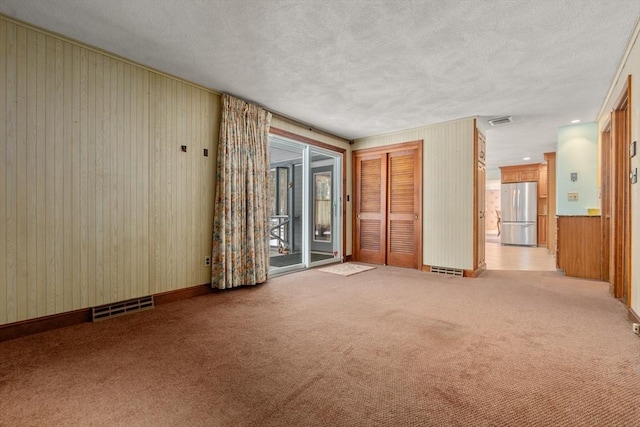 12 Checkerberry Cir, Sudbury, MA 01776 - empty room with wooden walls, light carpet, and a textured ceiling