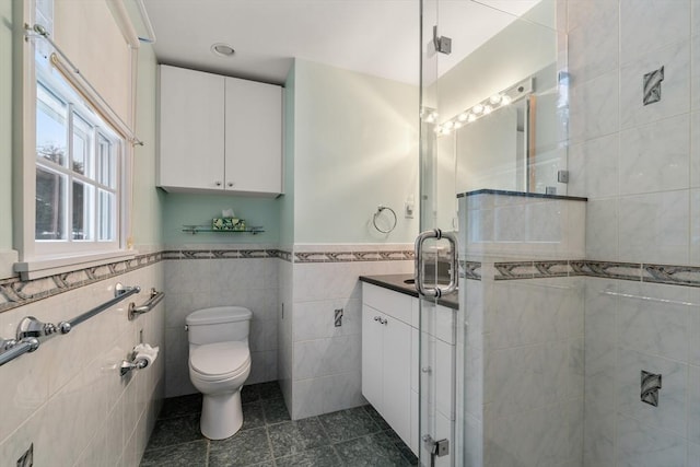 12 Checkerberry Cir, Sudbury, MA 01776 - bathroom with tile walls, tile patterned floors, vanity, a shower stall, and wainscoting