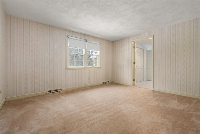 12 Checkerberry Cir, Sudbury, MA 01776 - unfurnished room with wallpapered walls, carpet, and a textured ceiling