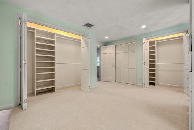 12 Checkerberry Cir, Sudbury, MA 01776 - unfurnished bedroom with two closets, light carpet, and recessed lighting