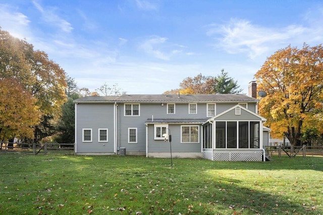 12 Checkerberry Cir, Sudbury, MA 01776 - rear view of property with a chimney, a sunroom, and a fenced backyard