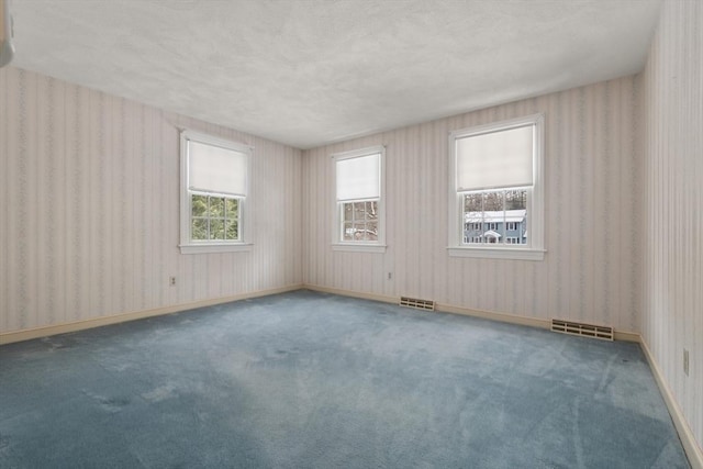 12 Checkerberry Cir, Sudbury, MA 01776 - carpeted empty room featuring a textured ceiling and wallpapered walls