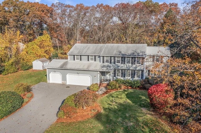 12 Checkerberry Cir, Sudbury, MA 01776 - colonial house featuring driveway, a front lawn, a garage, and a chimney