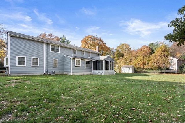 12 Checkerberry Cir, Sudbury, MA 01776 - rear view of house featuring a sunroom, a storage shed, and a chimney