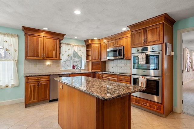 12 Checkerberry Cir, Sudbury, MA 01776 - kitchen featuring appliances with stainless steel finishes, open shelves, brown cabinetry, dark stone counters, and light tile patterned floors