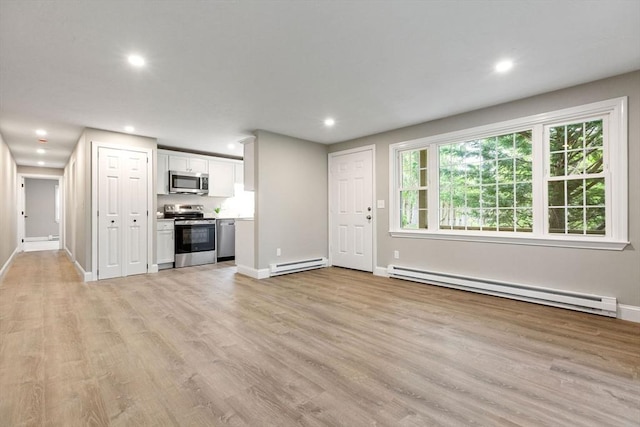 1029 Iyannough Rd Unit 9B, Barnstable, MA 02601 - unfurnished living room featuring a baseboard heating unit, recessed lighting, light wood-style floors, and baseboards