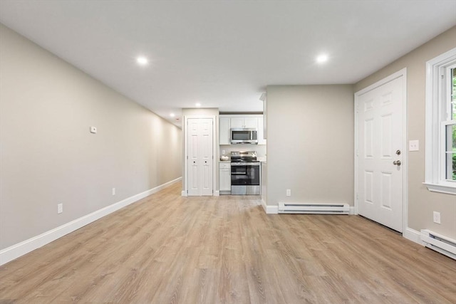 1029 Iyannough Rd Unit 9B, Barnstable, MA 02601 - unfurnished living room featuring light wood-type flooring, baseboard heating, baseboards, and recessed lighting