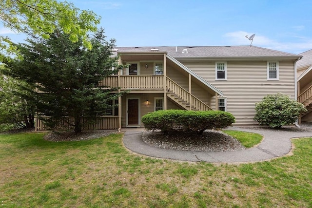 1029 Iyannough Rd Unit 9B, Barnstable, MA 02601 - rear view of house featuring stairs, a lawn, and a wooden deck