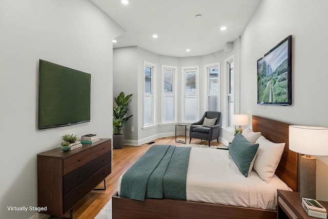 bedroom with recessed lighting and light wood finished floors